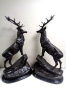 A pair of bronze figures of a stags stood upon a rocks on oval black marble bases (height 66.5cm).