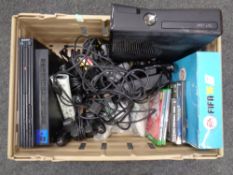 A box containing a Playstation 2 and Xbox 360 with leads and controllers together with assorted