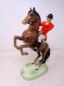 A Beswick figure, Huntsman on rearing horse No.