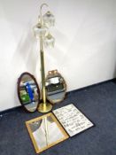 A brass three way floor lamp together with a framed print and three framed mirrors.