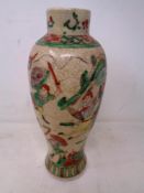 A Japanese crackle glaze vase depicting a battle scene (height 28cm).
