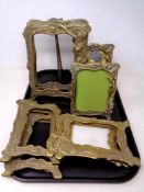 A tray containing eight brass Art Nouveau style picture frames.