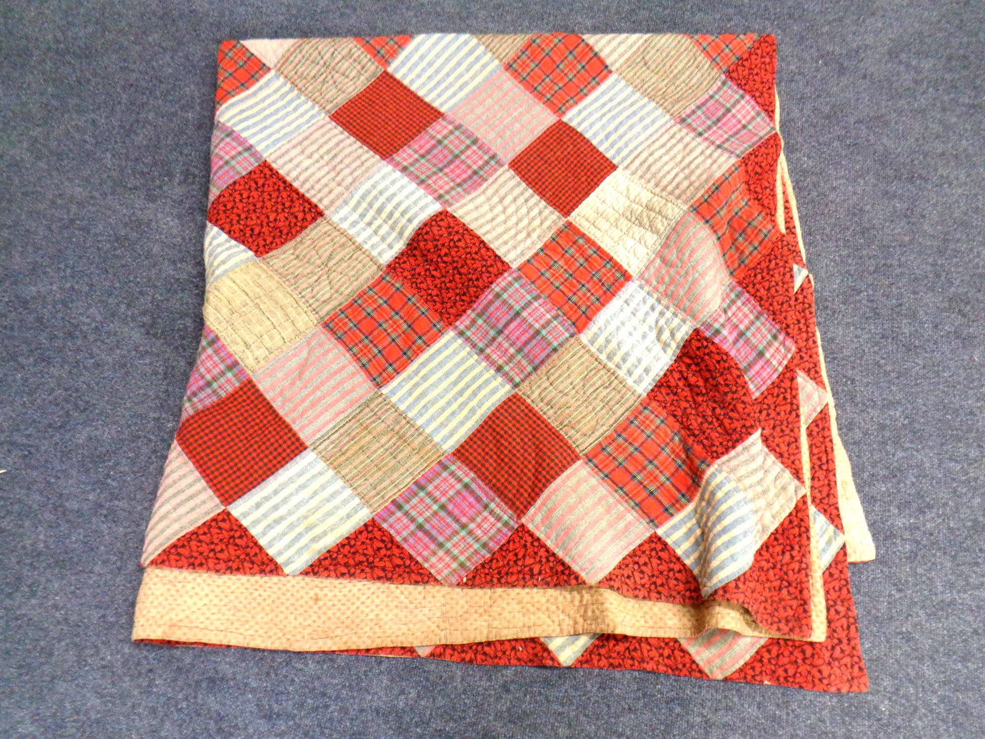 A hand-stitched patchwork quilt.