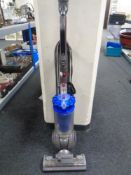 A Dyson DC41 upright ball vacuum with tools.