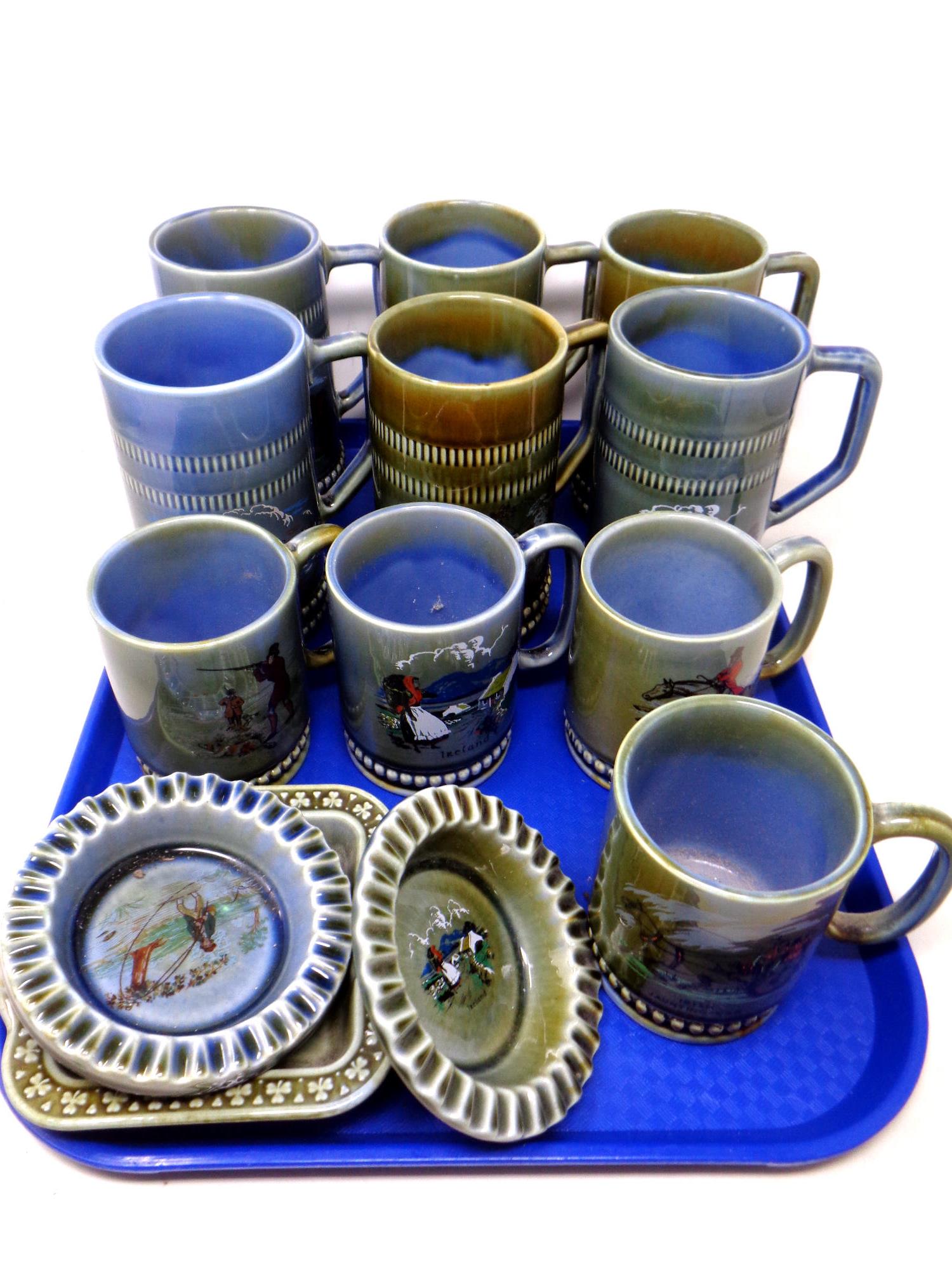 A tray containing 13 pieces of Irish Co Armagh ceramics including tankards and ash trays.