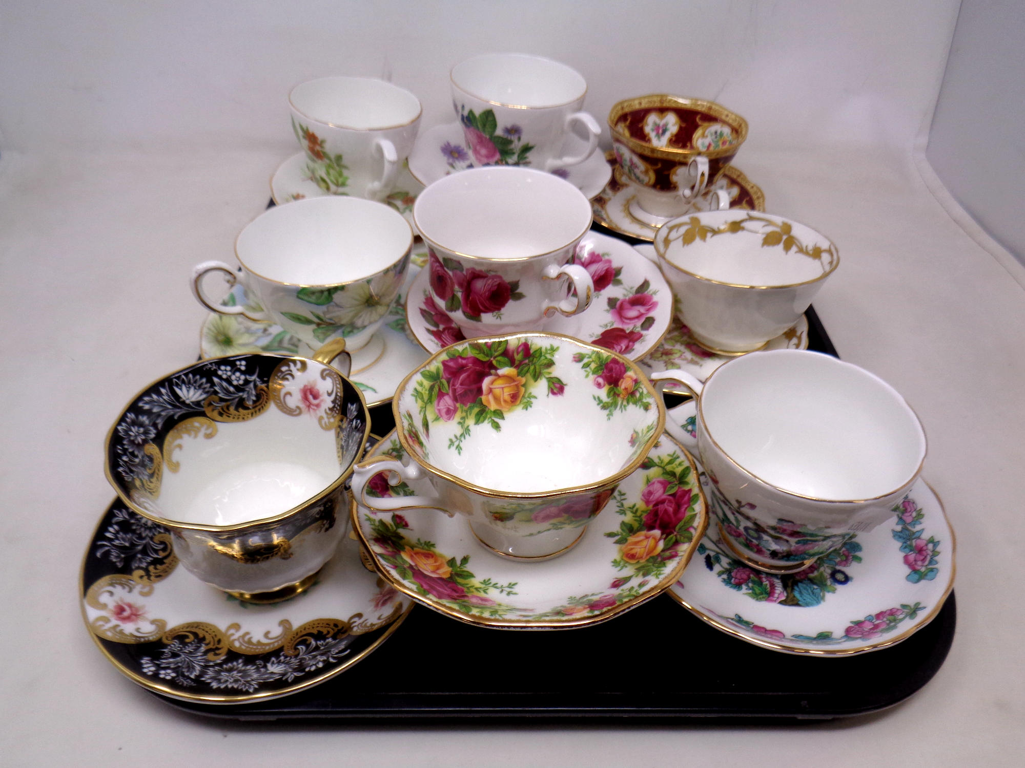 A tray containing nine assorted bone china teacups and saucers including Lady Beth, Royal Albert,