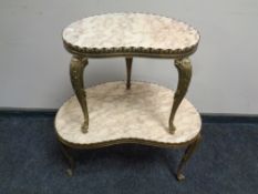 A nest of two brass and marble kidney shaped tables.
