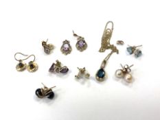Eight pairs of 9ct gold stud earrings and a 9ct gold topaz pendant on chain.