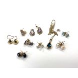 Eight pairs of 9ct gold stud earrings and a 9ct gold topaz pendant on chain.