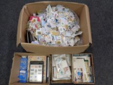 Three boxes containing a vast quantity of loose stamps, postcards, a stamp album.