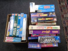 Three boxes containing assorted board games and jigsaw puzzles.