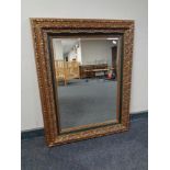 A contemporary bevel edged mirror in green and gilt frame.