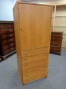 An oak single door office cabinet fitted with drawers beneath