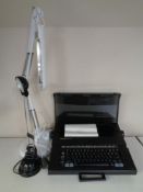 A Silver Reed EX43N electric typewriter in case together with two desk lamps.