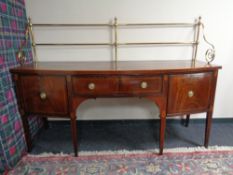 A Regency mahogany and satinwood inlaid bow fronted serving table with brass rail back fitted a