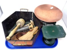 A hexagonal copper twin handled pot containing vintage kitchen tools,