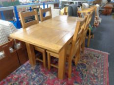 A Barker & Stonehouse contemporary oak extending dining table fitted with leaf together with a set