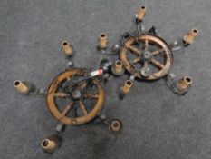 A pair of wrought iron cart wheel five branch chandeliers