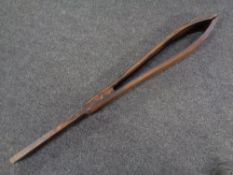 An antique wooden saddle clamp