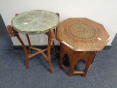 An Eastern octagonal occasional table with brass inlay together with a further folding brass topped