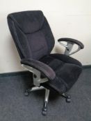 An executive high back swivel armchair upholstered in stitched fabric.