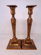 A pair of plated classical candlesticks (height 27cm).