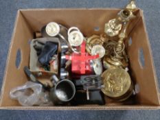 A box containing brass lamps, a table candelabra, kitchen scales, a cast iron door stop etc.