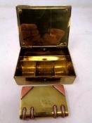 A vintage brass Gesch German stamp box together with a further brass and copper lighter in the form