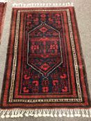 A fringed Iranian rug 112 cm x 170 cm
