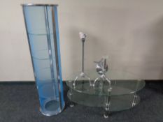 A contemporary metal and glass oval coffee table together with similar bathroom stand and bathroom