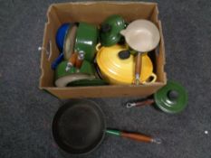 A box containing a quantity of Le Creuset cast iron frying pans,