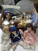 Two boxes containing assorted collectors dolls, whisky jugs, blue and white meat plates,