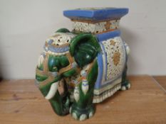 A ceramic elephant plant stand