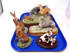 A tray containing five Border Fine Arts figures, three on wooden plinths.