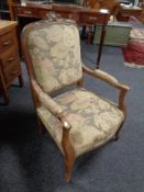 A French walnut tapestry upholstered armchair.