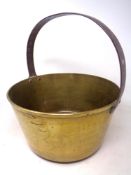 An antique brass cast iron handled jam pan