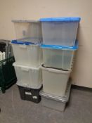 Eight plastic storage crates with lids.