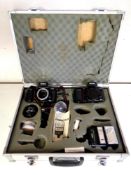 An aluminium camera case containing two Nikon F-801 cameras, lenses, flash, filters.