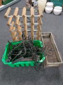 A crate containing wrought iron wall brackets, candle holders etc,