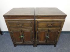 A pair of Chinese style double door side cabinets fitted with a drawer.