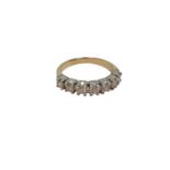 An 18ct white gold seven stone diamond half eternity ring, approximately 0.7ct, size P.