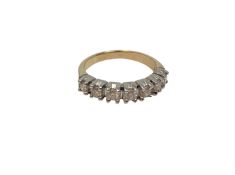 An 18ct white gold seven stone diamond half eternity ring, approximately 0.7ct, size P.