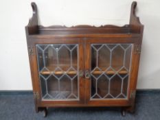 A Jaycee Furniture double door wall cabinet with leaded glass doors.