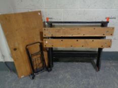 A folding work bench together with a miniature sack barrow.
