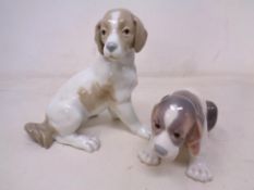Two Lladro figures of puppies.