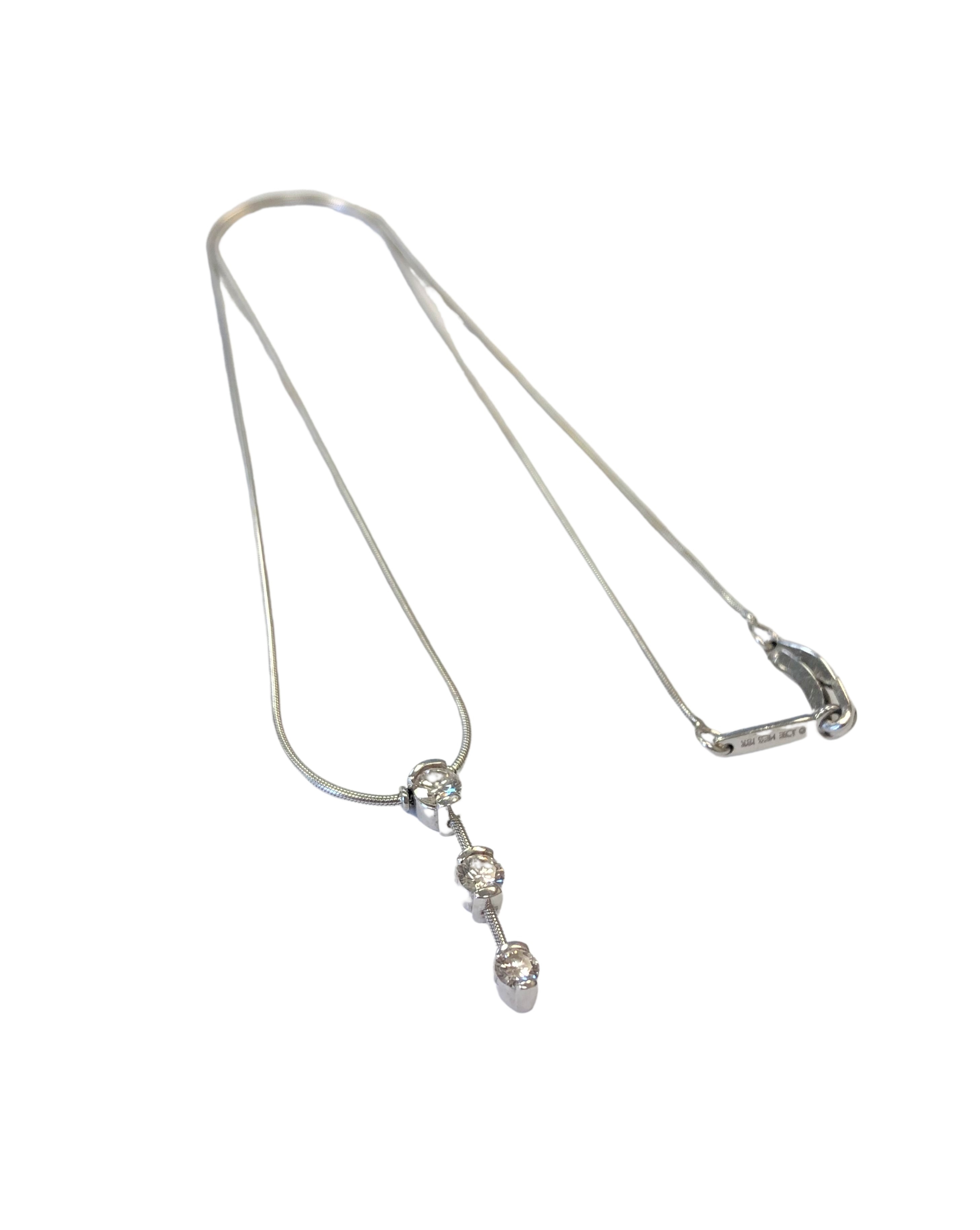 An 18ct white gold three stone diamond necklace, approximately 0.