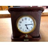 Early twentieth century leather cased travelling alarm clock.