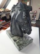 A horse head sculpture on marble base (height 36cm).