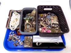 A tray containing assorted costume jewellery including charm bracelets, bracelets, brooches,