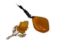 An amber pendant and an .835 silver mounted brooch stamped SBM.